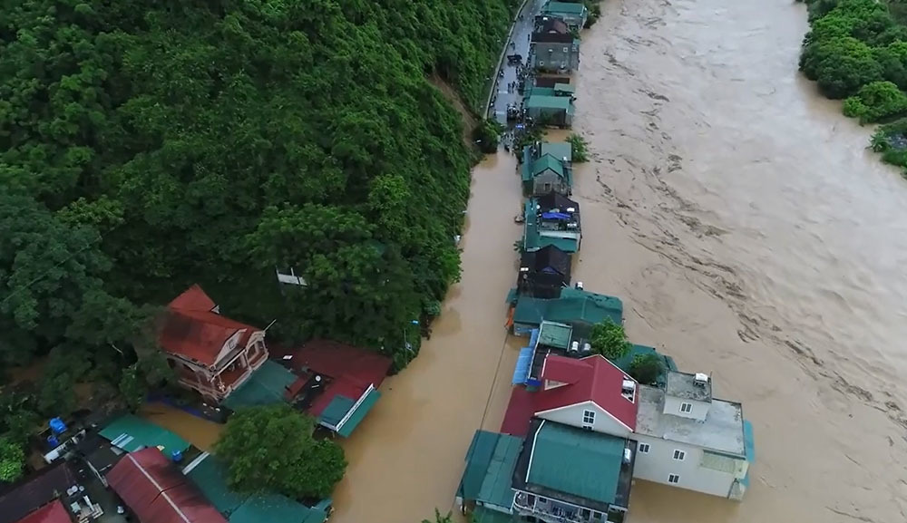 Nước lũ cuồn cuộn chực 'nuốt' nhà chênh vênh bên sông