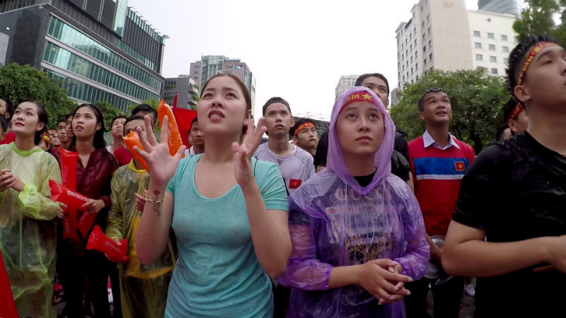 Cổ động viên đội mưa cỗ vũ Olympic Việt Nam