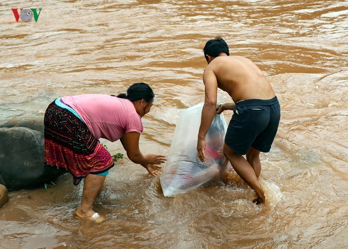 Học sinh chui túi nilon vượt suối lũ tới trường ở Điện Biên
