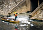 Environment workers clean up To Lich river