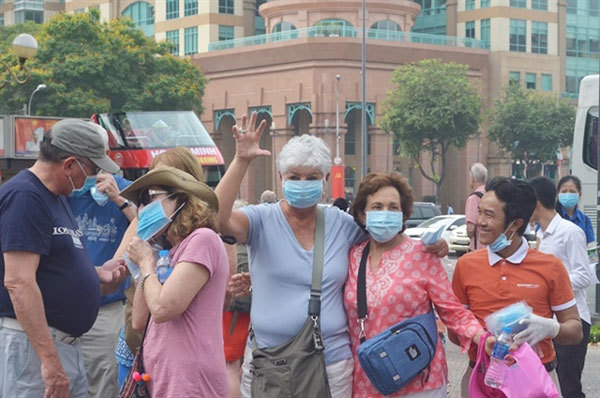 Locals, tourists receives free masks in HCM City