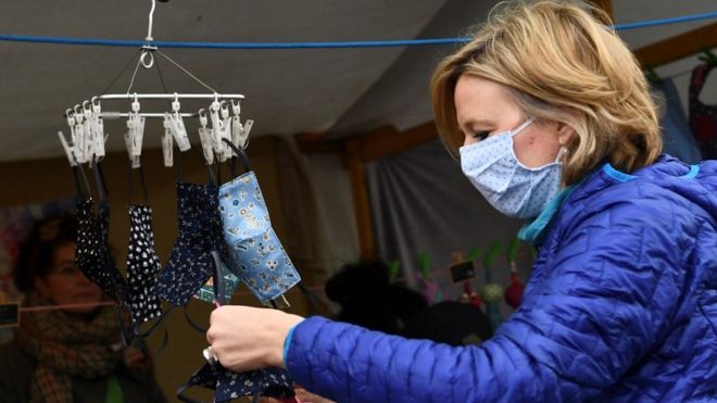 Coronavirus: Germans don compulsory masks as lockdown eases