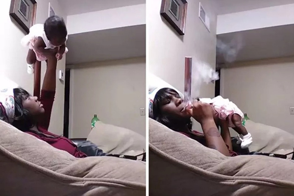 Người mẹ bế con 1 tuổi như nâng tạ vừa phì phèo điếu thuốc