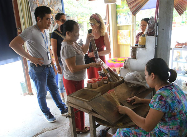 Sights and smells of incense making village lure tourists