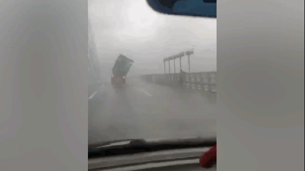 Gió thổi bay thùng container khi xe băng qua cầu trong bão