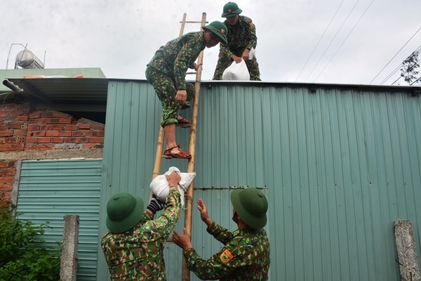 Bộ đội, công an giúp dân chằng chống nhà cửa phòng bão số 9