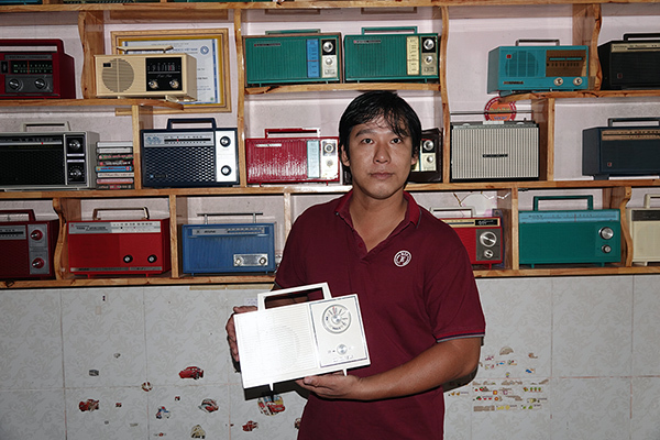 Young man and his splendid home-based antique exhibition