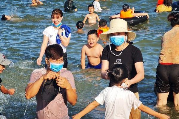 Du khách đeo khẩu trang tắm biển ở Sầm Sơn