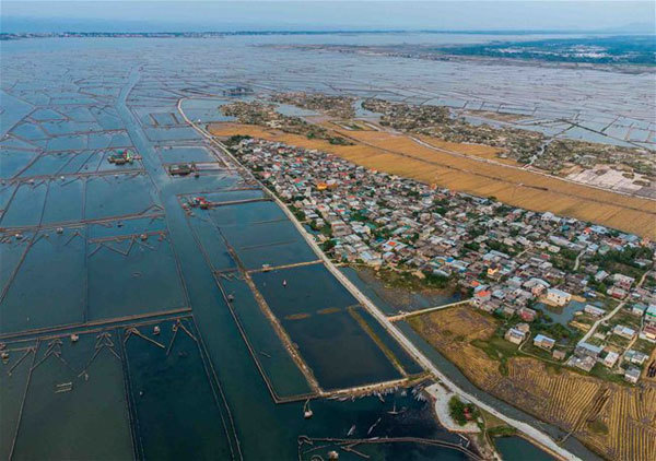 Tranquil village by largest brackish lagoon in Southeast Asia
