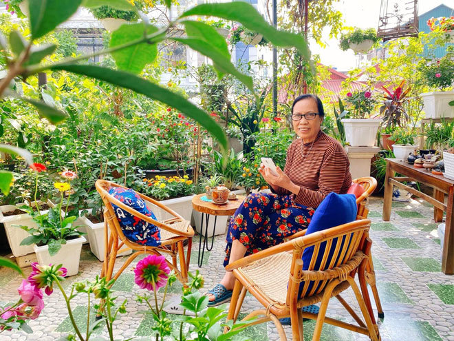Hanoi house outside covered with flowers, on the terrace shimmering colors