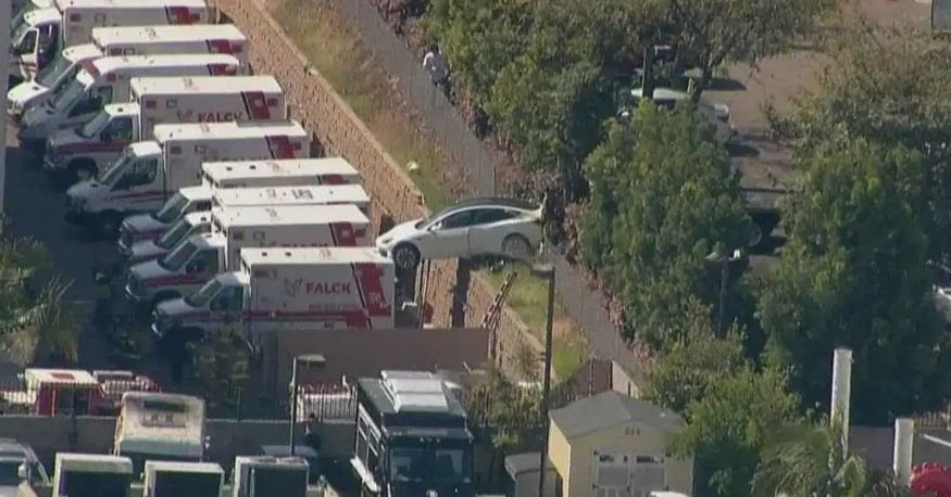 The driver got the wrong gas pedal, the car flew over the fence, landed on the roof of the ambulance